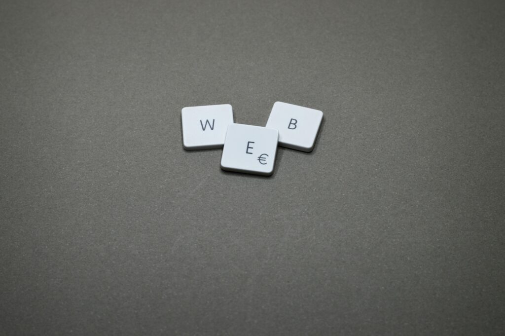 Minimalist image of keyboard keys spelling 'WEB' on a plain background.